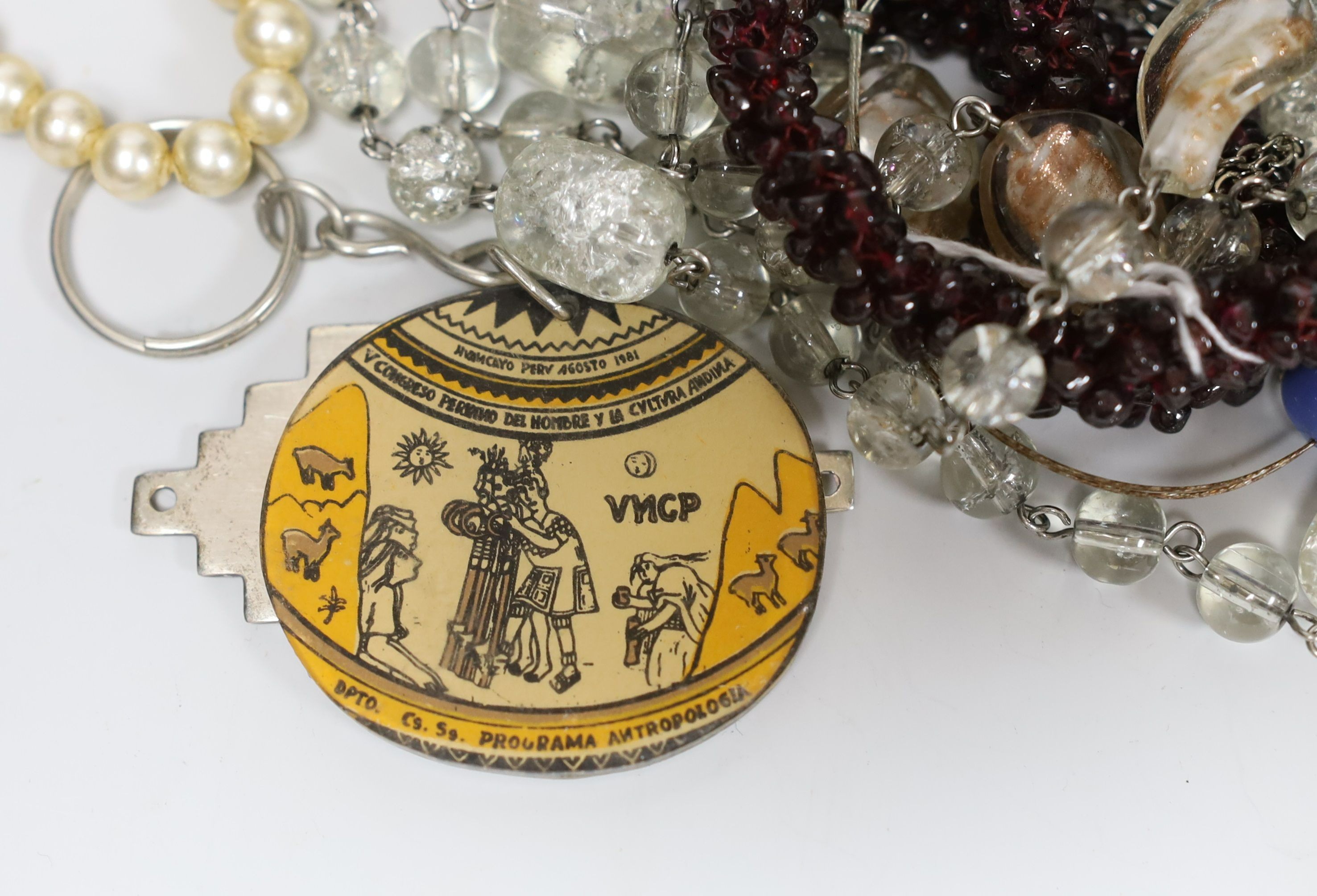 A quantity of assorted costume jewellery and other items including silver and enamel plaque and a garnet bead necklace.